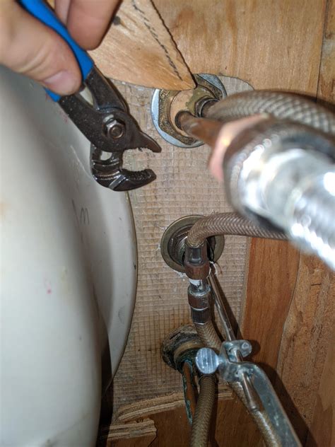 Maintenance - Spray head screen maintenance on a kitchen faucet. . Remove kitchen faucet nut